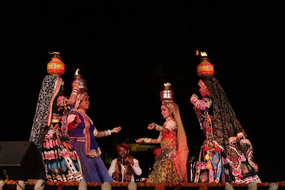 Vibrantly dressed dancers performing a traditional tribal dance