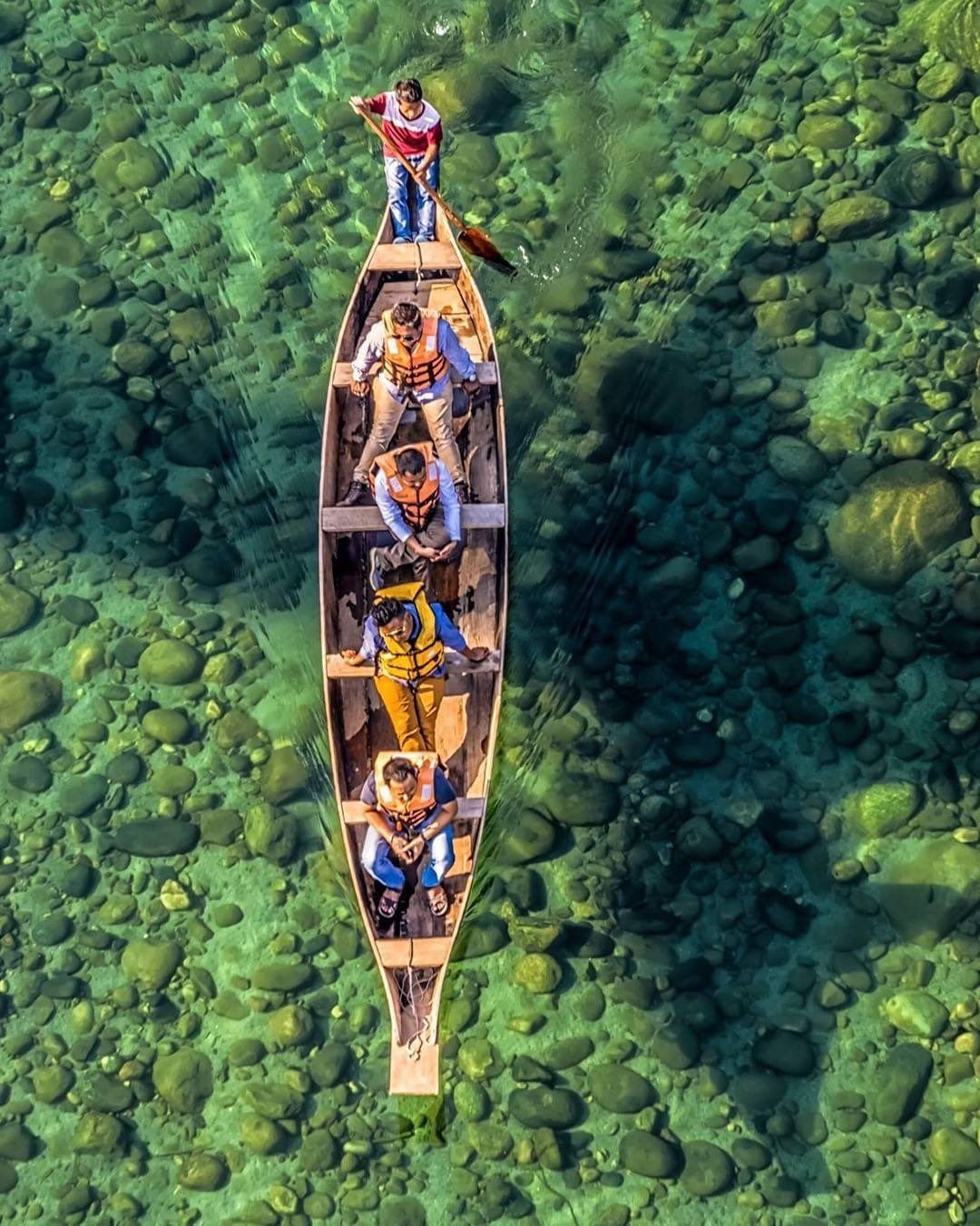 A view of the clear Umngot River with traditional boats in Dawki/Shnongpdeng.