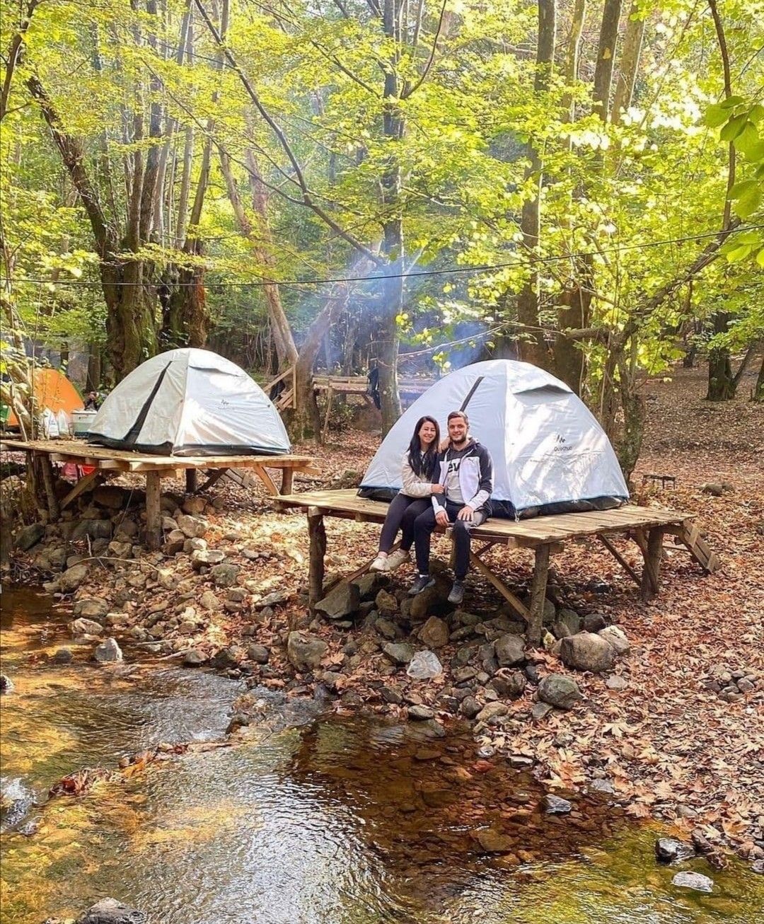 A person climbing or navigating a waterfall during a canyoning trip