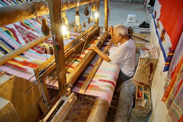 A traditional weaving loom with a local artisan working on it.
